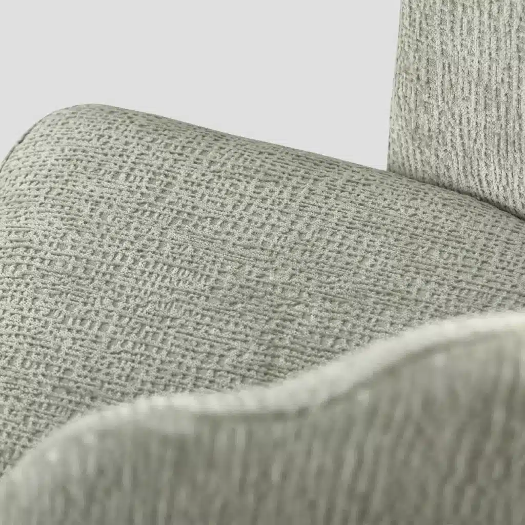 détail de l'assise de la chaise qui met en évidence le tissu vert moderne légèrement gaufré.