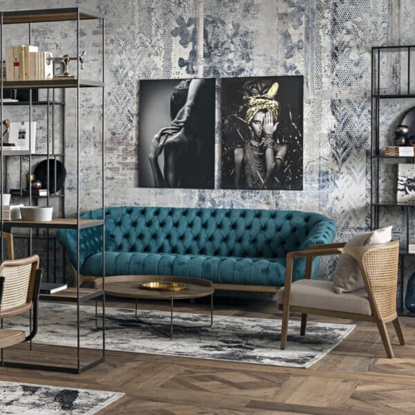 salon de style Industriel Chic avec canapé bleu, table basse ronde et étagères bois et métal, cadres au mur.